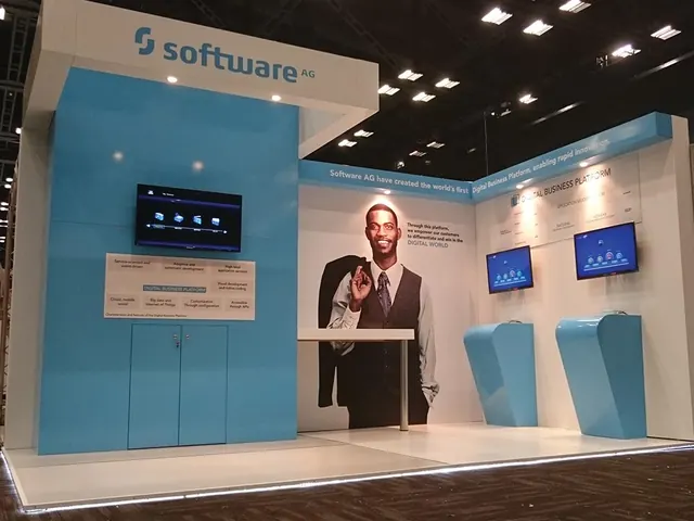 A light-blue Software AG stand with screens and a large printed figure