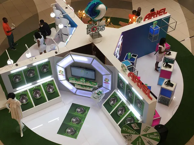 An Ariel 3in1 Pods mall activation seen from above, with a wall of washing-machine doors and a prize wheel