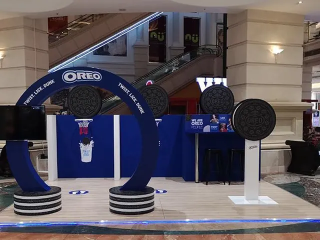 An Oreo mall activation with giant cookie arches and a blue stage